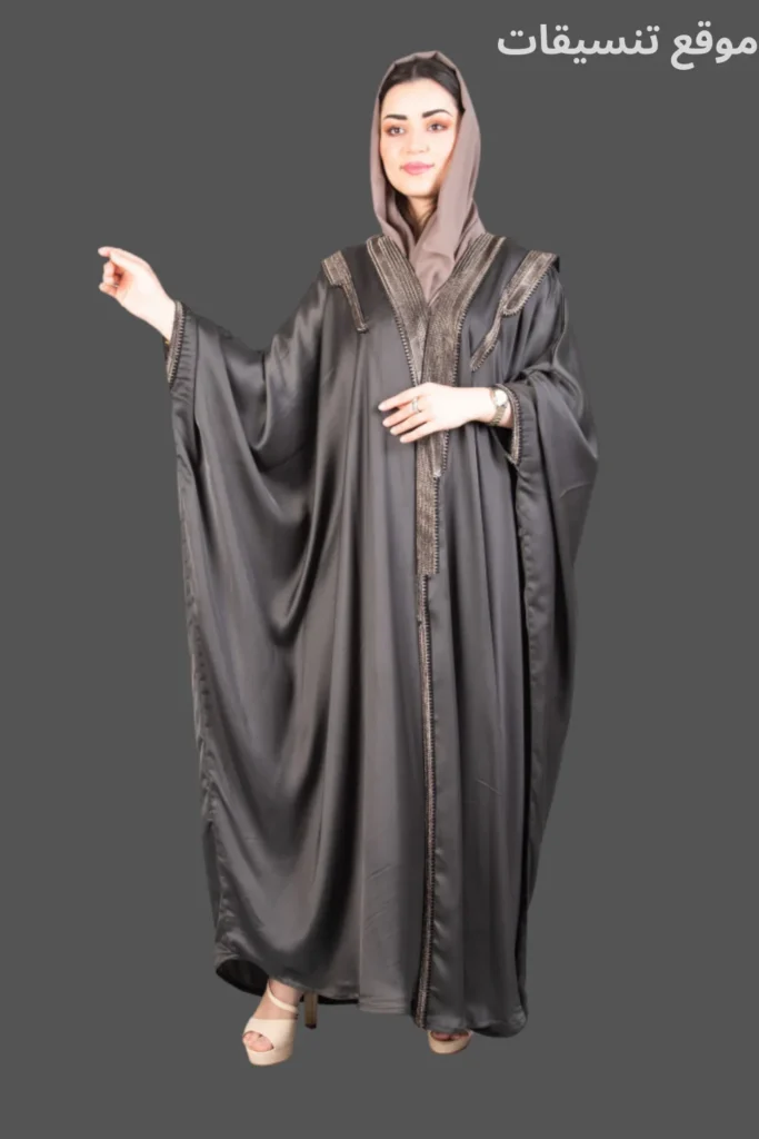 عباية بشت رمادي غامق بقماش لامع مع تطريز دقيق على الأكمام والصدر وإطلالة فخمة.
